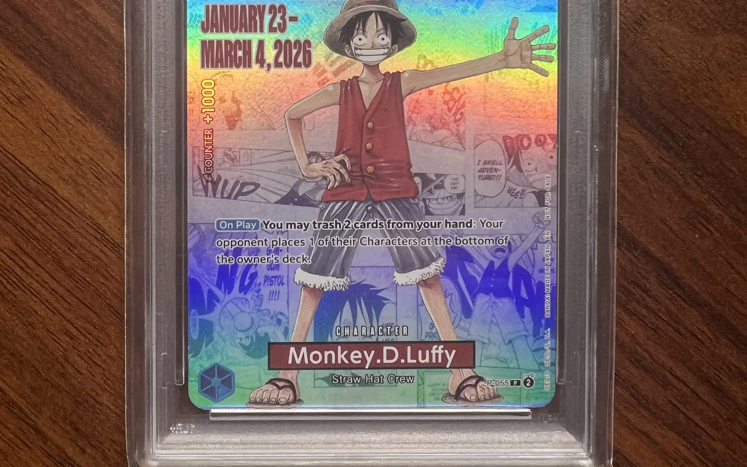 Eine gegradete One-Piece-Karte mit Monkey D. Luffy in einem verschweißten PSA-Gehäuse, der Rand des Gehäuses ist unten zu sehen.
