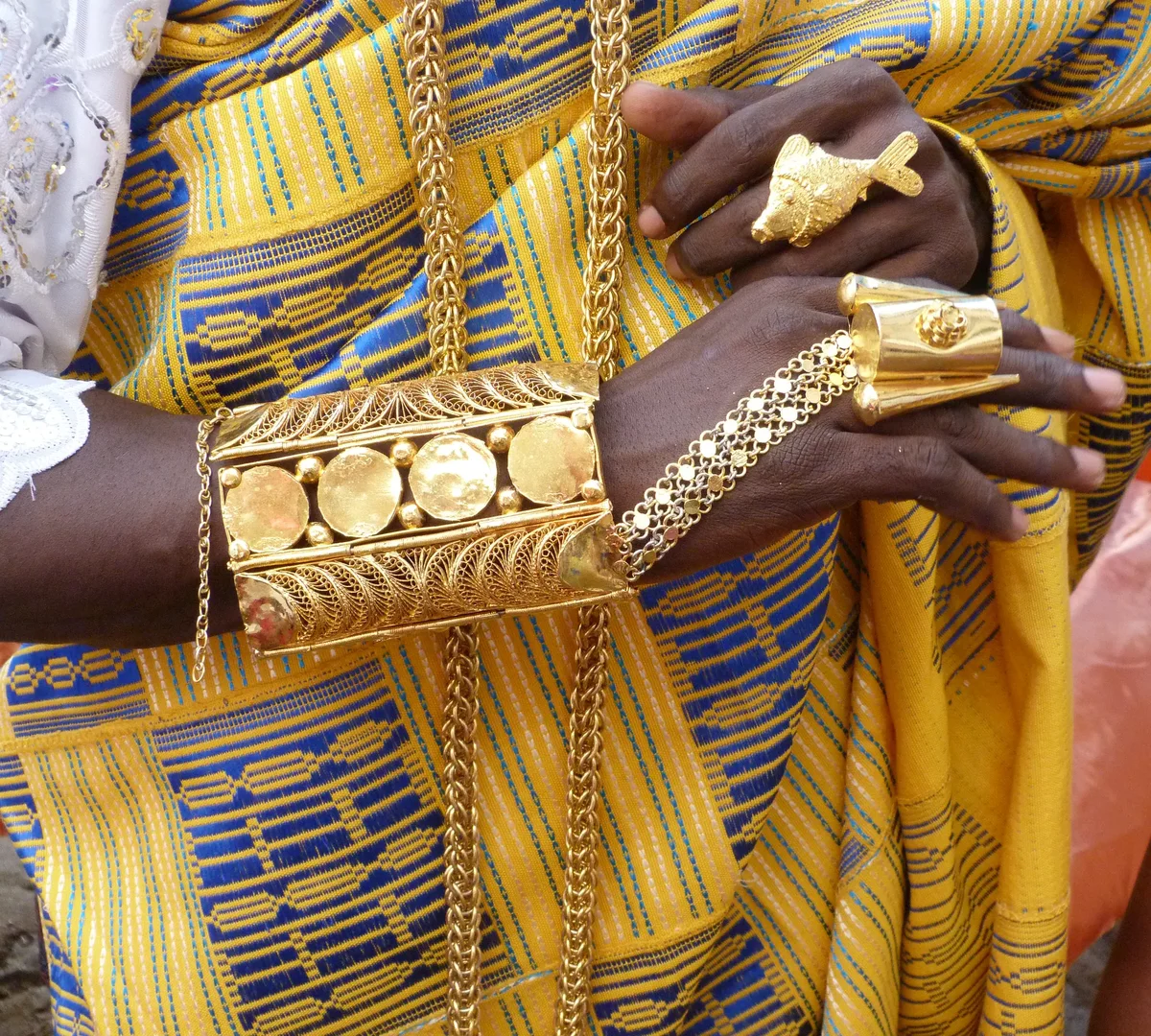 Goldschmuck mit Filigranarbeit an Händen mit traditionellem Gewand
