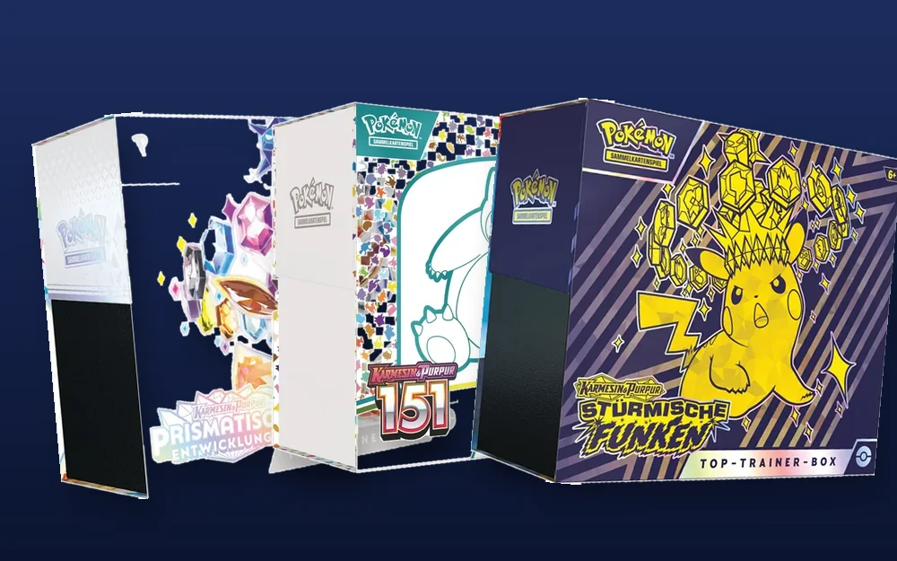 Drei versiegelte Elite-Trainer-Boxen aktueller Pokémon-Sets nebeneinander